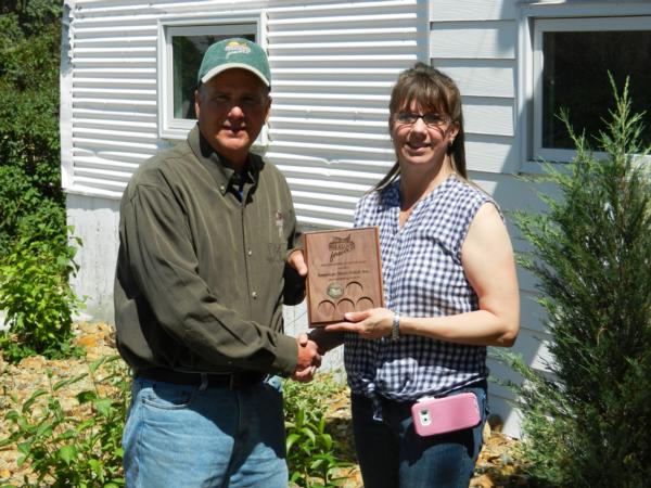 Randy Piearson, Headwaters president, presents Lisa Ruyal of American Sheet Metal with a 2015 major Headwaters sponsorship award.  Owners, Adam & Dawn Dorrington are advent supporters of Pheasants Forever.
